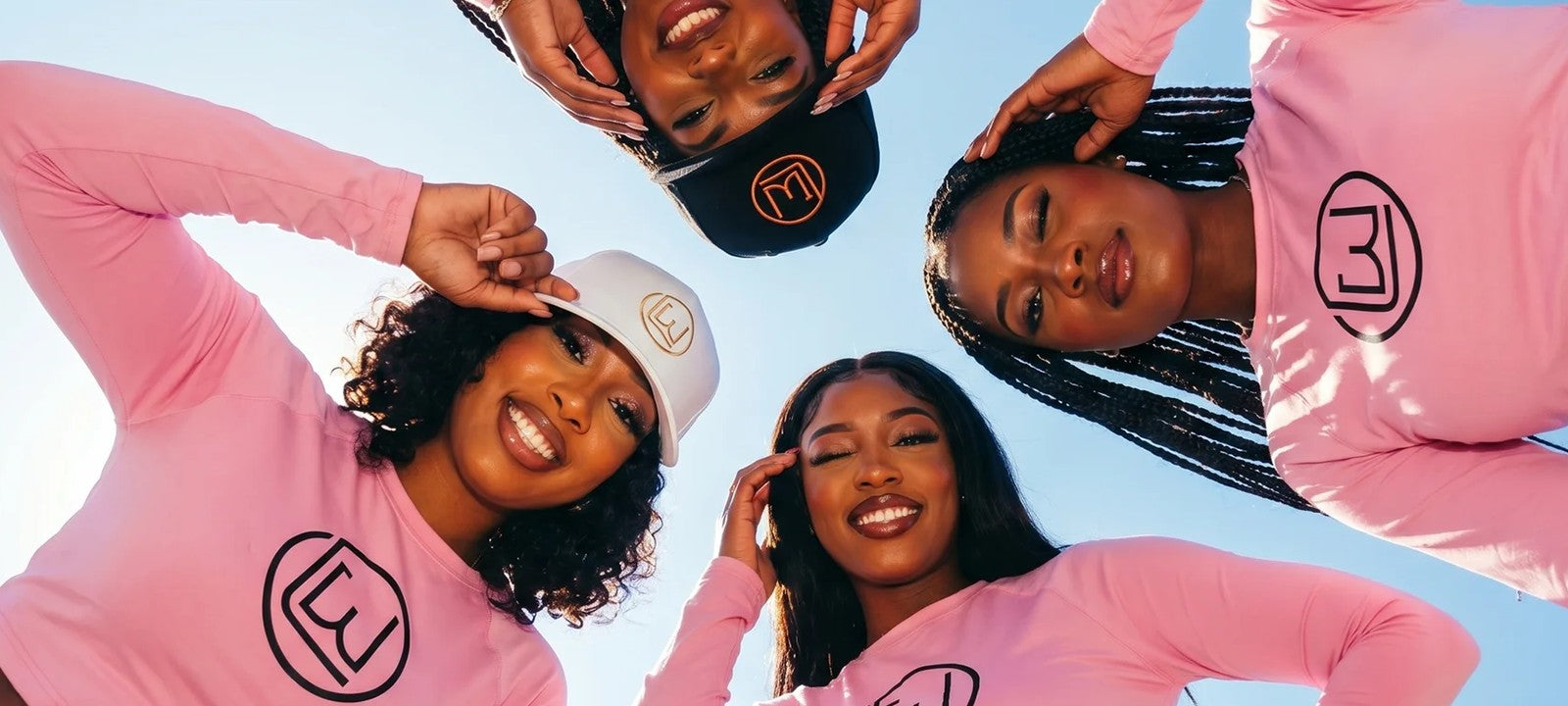 Women in Laron Wear pink hoodies and caps